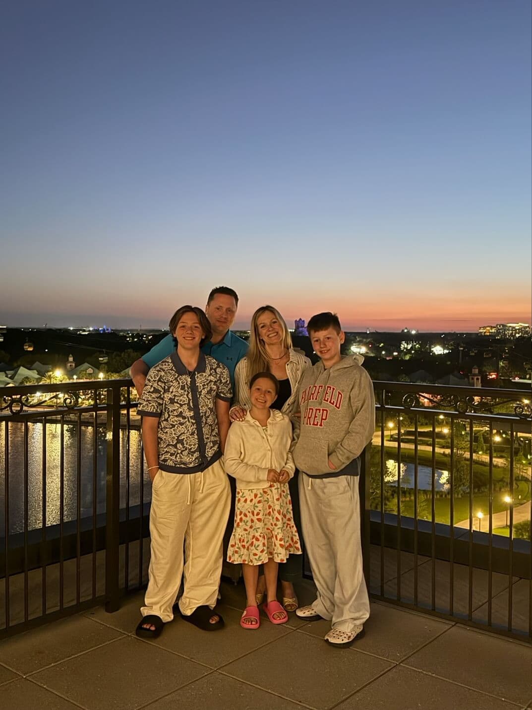 A family portrait on a balcony at sunset