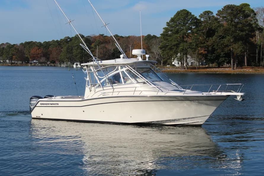 Blue Syndicate III — Grady-White Express 330 under way, outriggers up and twin Yamaha outboards astern
